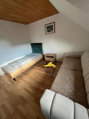 a bedroom with a bed and a couch and a table at Mira Home in Murg