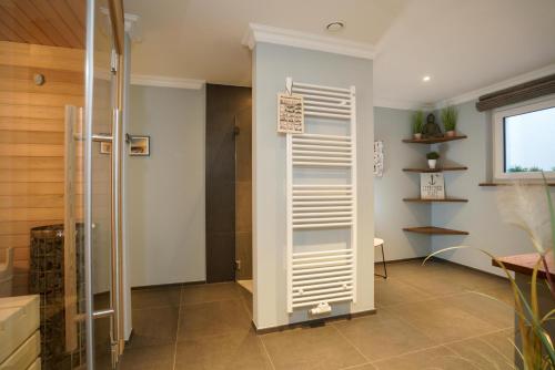 a bathroom with a shower with a glass door at Ferienhaus Sylt Leev in Westerland