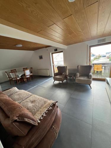 a living room with a couch and chairs and a table at Mira Home in Murg