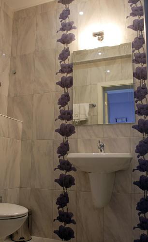 a bathroom with a sink and a mirror at Avenue in Shumen