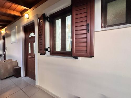 a hallway with wooden doors and a window at Julie's Home in Kalavrita