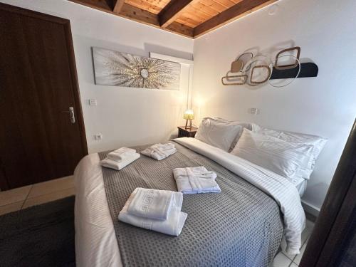 a bedroom with a bed with towels on it at Julie's Home in Kalavrita