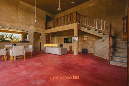 a living room with a staircase and red carpet at Casa na pedra em Serra Negra vista para montanha in Bezerros