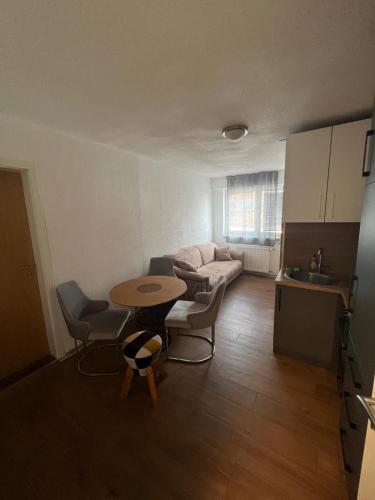a living room with a table and a couch at Era Home in Murg