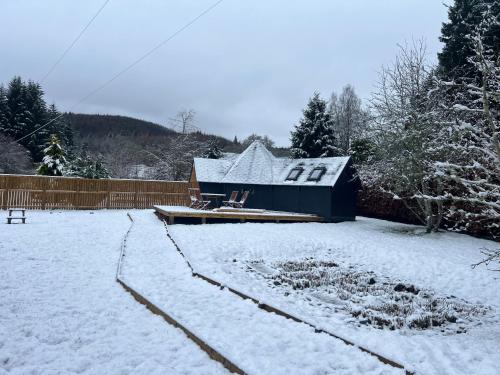 a house in a yard covered in snow at Hatton Lodge in Dunkeld