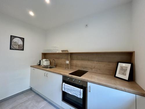 a kitchen with a counter top and a sink at StayRoom Apartments - RK2 in Linz