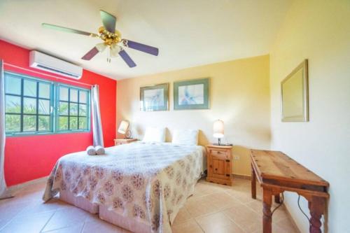 a bedroom with a bed and a ceiling fan at Palma Real 28 - 2-Bedroom Vacation Condo in Palm Beach, Aruba in Palm-Eagle Beach