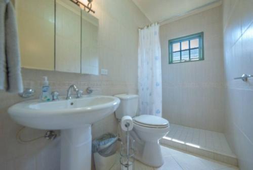 a bathroom with a sink and a toilet and a shower at Palma Real 28 - 2-Bedroom Vacation Condo in Palm Beach, Aruba in Palm-Eagle Beach