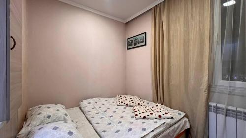 a small room with a bed and a window at Apartment ANI in Vagharshapat