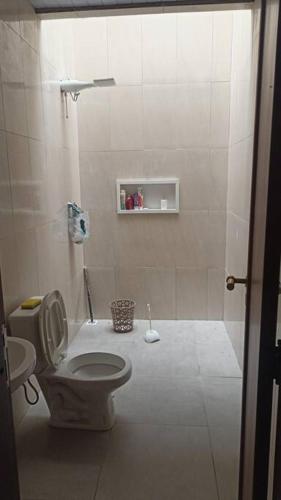 a white bathroom with a toilet and a shower at casa de praia ReJ 2 in Itapoa