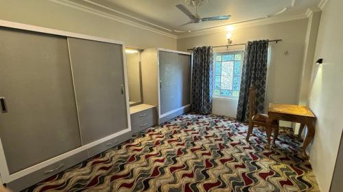an empty room with a large room with a dressing room at Soul's Abode in Srinagar