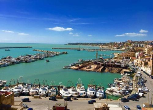 a bunch of boats are docked in a harbor at Vittoria House in Sciacca