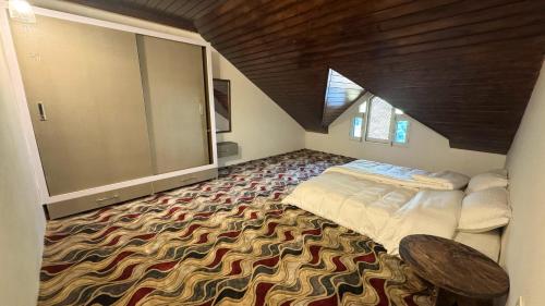 a bedroom with a bed and a large rug at Soul's Abode in Srinagar