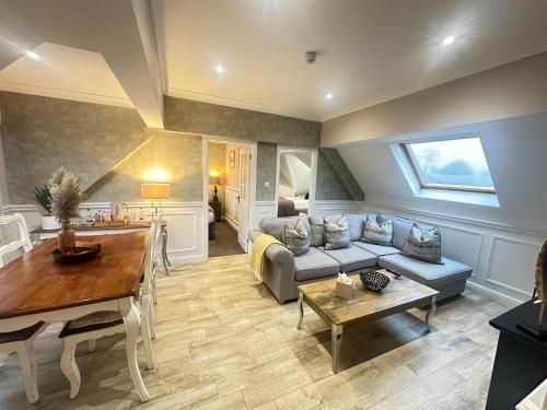 a living room with a couch and a table at The Inn At Grasmere in Grasmere