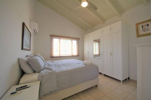 a bedroom with a bed and a couch at Paradera Paradise - your ultimate 5-bedroom getaway in Paradera