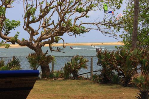 a view of a beach with a fence and the ocean at Villa Santé by The Serendipity Collection in Kalpitiya