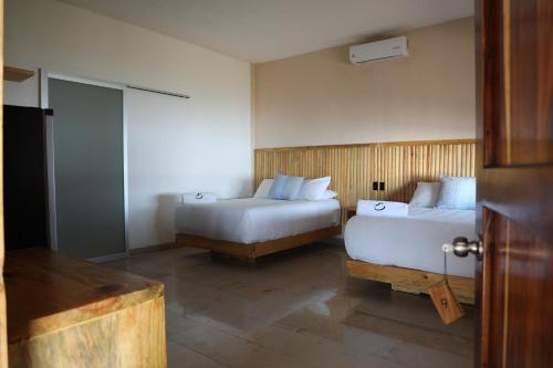 Postel nebo postele na pokoji v ubytování Hotel Playa Zipolite