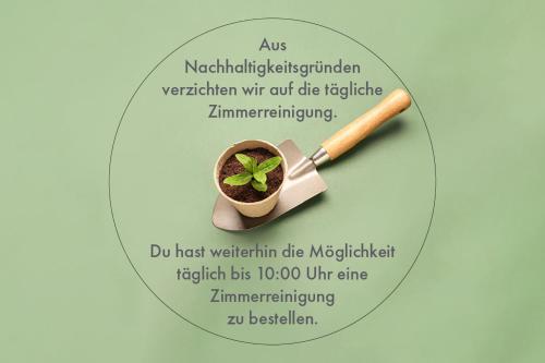a label with a plant in a pot and a baseball bat at Coffee Fellows Hotel Dortmund in Dortmund