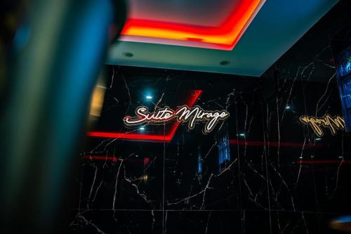 a neon sign on the wall of a restaurant at Découvrez la Suite Mirage à 30 minutes de Paris in Pontoise