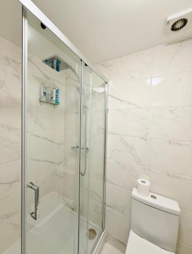 a bathroom with a shower and a toilet at Winners of 2025 traveller Award, Elegant two bedroom city central apartment with Netflix & WiFi in Leeds