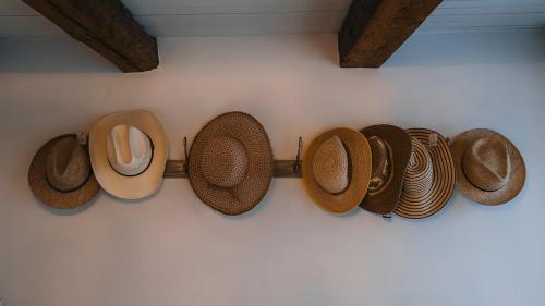a row of hats hanging on a wall at Köpmans Boutique Hotel & Bistro in Höganäs