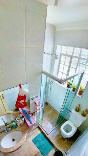 a bathroom with a shower and a toilet and a sink at Casa Diamantina in Diamantina