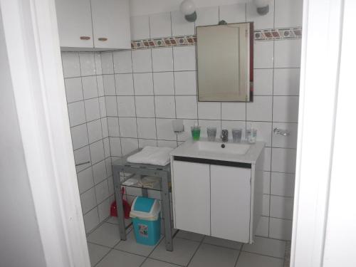 a white bathroom with a sink and a mirror at MANIKOU in Le Vauclin