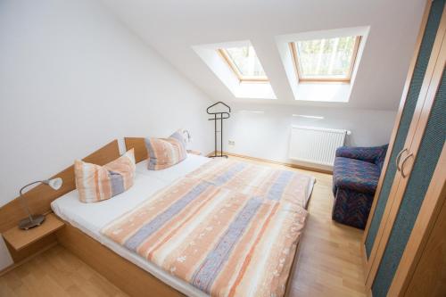 a large bed in a room with a window at Ferienhaus Waldschneise B am Jabeler See in Jabel