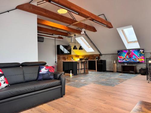 a living room with a couch and a flat screen tv at Apartamenty Stodoła in Kajkowo