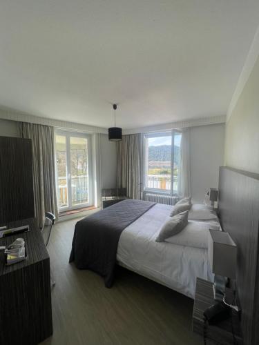 Ένα ή περισσότερα κρεβάτια σε δωμάτιο στο Hôtel La Réserve