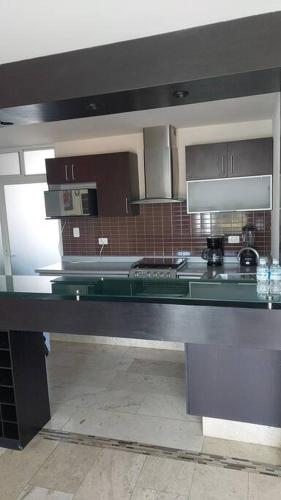 a kitchen with a black counter top in a room at Departamento en Cholula Pue La Concordia C4 in Acatepec
