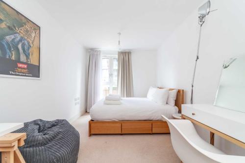 a bedroom with a bed and a large window at Cosy Central Urban Retreat in Highbury & Islington in London