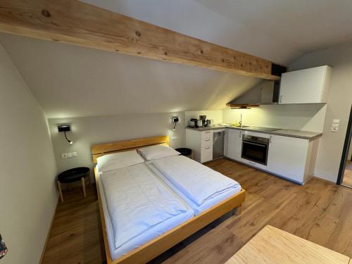 a small bedroom with a bed and a kitchen at Felbermayer Appartements in Gaschurn