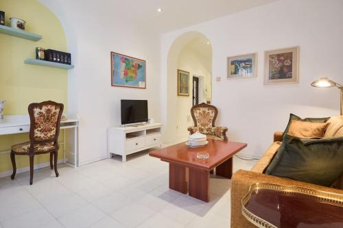 a living room with a couch and a tv at La casa di Visi in Milan