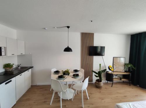 a kitchen with a table and chairs in a room at Sauna, Pools mit XXL-Terasse oder Kinderkino in Sankt Englmar