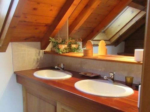 a bathroom with two sinks and a wooden counter at Chalet Face aux Etoiles in Molines-en-Queyras