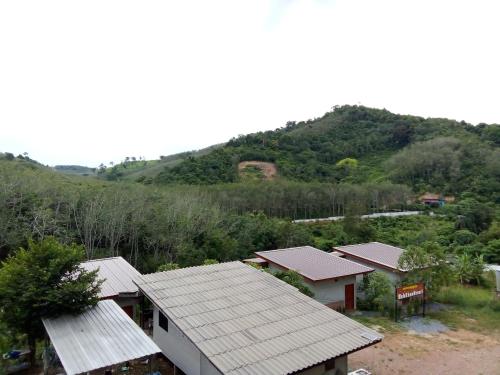 an overhead view of a house with a mountain in the background at Hubkhao Resort in Ko Lanta