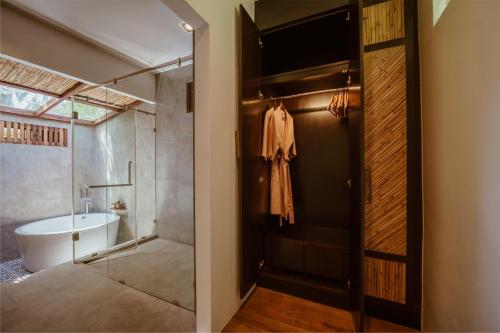 a bathroom with a shower and a toilet and a sink at Ban Sainai Resort- Aonang's Green Resort in Ao Nang Beach