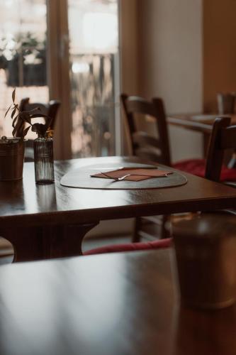 a wooden table with chairs and a table with a plate on it at Guesthouse Giulietta e Romeo in Cossogno