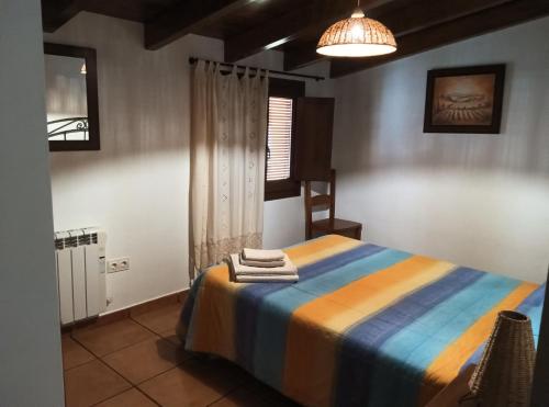 a bedroom with a bed with towels on it at Casa la Cisterna in Pina de Montolgrao