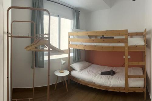 two bunk beds in a room with a window at Apartamento casalely in Murcia