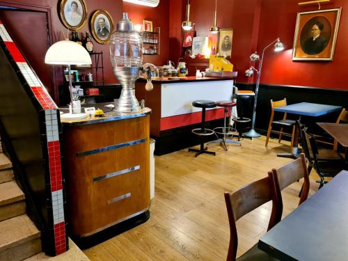 a restaurant with a counter and a table and chairs at B&B Casa Ortega in Marseille