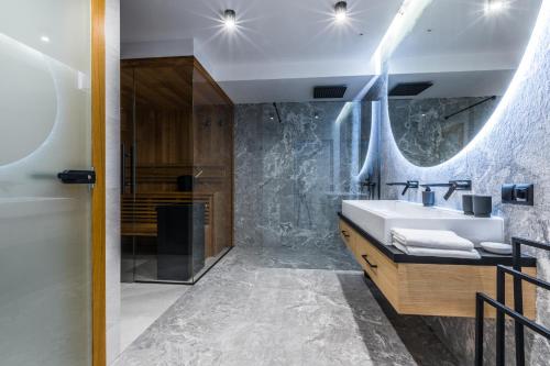 a bathroom with a sink and a mirror at Apartamenty Tatra Lux in Bukowina Tatrzańska