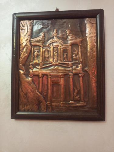 a painting of a building on a wall at بيت مزرعة ريفي in Madaba