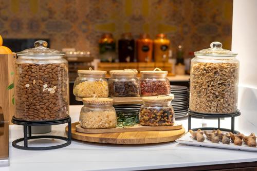 a group of jars of nuts and seeds on a counter at Thon Hotel Brussels City Centre in Brussels