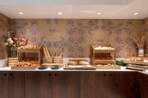 a bakery with various breads and pastries on display at Thon Hotel Brussels City Centre in Brussels