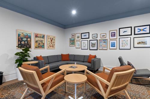 a living room with a couch and a table and chairs at HI Halifax Heritage House Hostel in Halifax