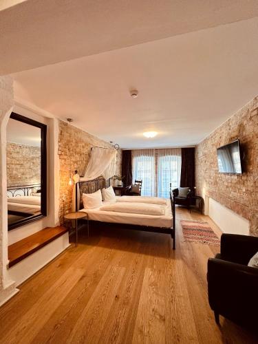 a bedroom with a bed and a brick wall at cinderella.kreuzberg in Berlin