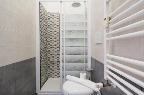 a bathroom with a toilet and a glass shower at Primopiano - Avogadro in Milan