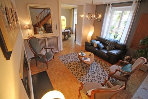 a living room with a couch and chairs and a table at Le clos jargot in Limoges